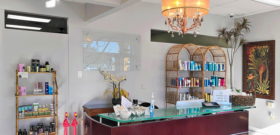 Josephine's Salon and Spa reception desk with chandelier and salon products