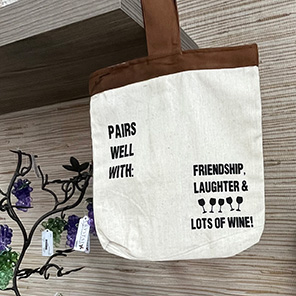canvas tote bag that says Pairs well with Friendship, Laughter, and Lots of Wine!